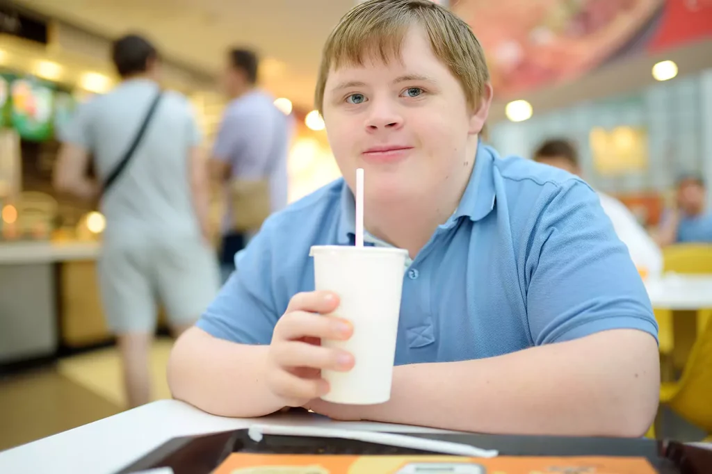 Disabled man in food court enjoying drink
